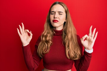 Sticker - Young blonde woman wearing turtleneck sweater relax and smiling with eyes closed doing meditation gesture with fingers. yoga concept.