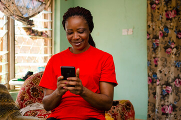 beautiful african woman gets excited about what saw on her cellphone