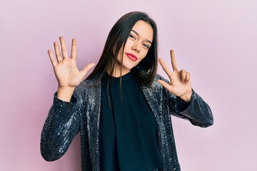 Poster - Young hispanic girl wearing party jacket showing and pointing up with fingers number eight while smiling confident and happy.