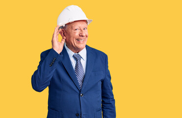 Wall Mural - Senior handsome grey-haired man wearing suit and architect hardhat smiling with hand over ear listening an hearing to rumor or gossip. deafness concept.