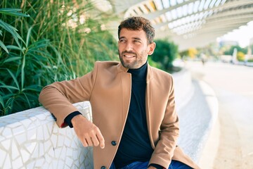 Handsome business man wearing elegant jacket smiling happy outdoors