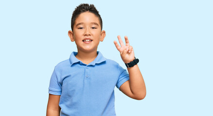 Sticker - Little boy hispanic kid wearing casual clothes showing and pointing up with fingers number three while smiling confident and happy.