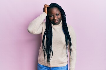 Sticker - Young black woman with braids wearing casual winter sweater confuse and wonder about question. uncertain with doubt, thinking with hand on head. pensive concept.