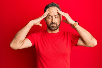 Sticker - Handsome middle age man wearing casual red tshirt with hand on head, headache because stress. suffering migraine.