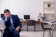 © Elnur - Young male employee with skeletons in the office