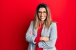 © Krakenimages.com - Beautiful brunette woman wearing business shirt and glasses happy face smiling with crossed arms looking at the camera. positive person.