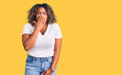 Wall Mural - Young african american plus size woman wearing casual clothes bored yawning tired covering mouth with hand. restless and sleepiness.