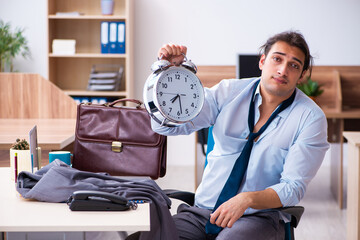 Wall Mural - Young male employee being late for his job