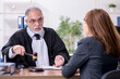 © Elnur - Old male judge and female client in the office