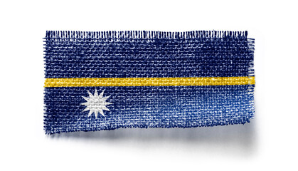 Nauru flag on a piece of cloth on a white background