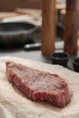 closeup raw seasoned new york steak on concrete countertop background