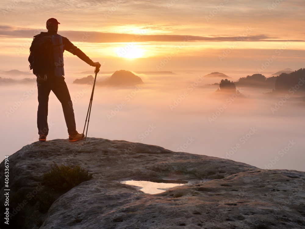 Man Silhouette With Poles In Hand. Sunny Spring Daybreak And  Guide Stay On  Cliff Of Mountain - obrazy, fototapety, plakaty 