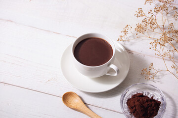 cup of hot chocolate with white wooden background