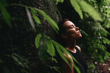 Attractive young woman among the tropical plants. Vacation. Tropics. Fashion shot.