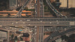 Cross highway top down at Philippines capital cityscape aerial shot. Cars, buses, vans, trucks are driving at traffic road of Manila city. Urban scene with buildings, skyscrapers, cottages at roadside
