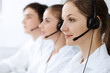 © rogerphoto - Call center. Beautiful young woman using headset and computer to help customers. Business concept