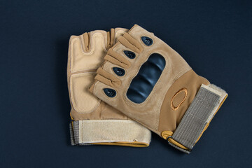 Pair of tactical gloves on dark background