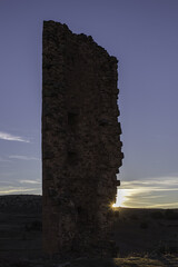 Sticker - Vertical shot of the ruins of an ancient castle on the sunset background