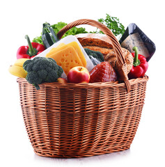 Wall Mural - Wicker basket with assorted grocery products isolated on white