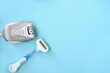 © Tatiana - Epilator against razor on a blue background. depilation methods for remove hair