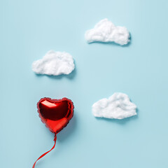 Canvas Print - Love layout made with red heart balloon and clouds on pastel blue sky background. Romantic Valentines day, anniversary or dating concept. Wedding greeting card. Flat lay, top view, copy space.