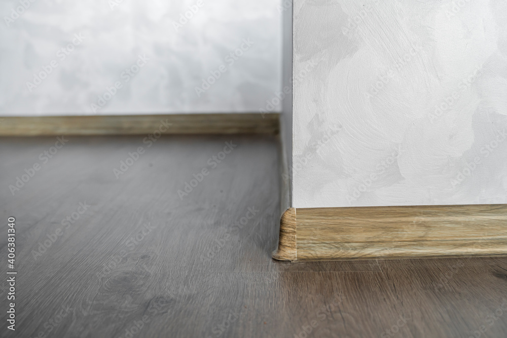 Picture Idea: Laminate With Plastic Baseboard With A Wooden Texture Newly Installed