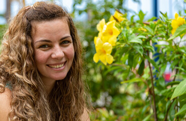 Brazilian blonde woman closeup in home garden