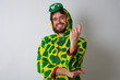 © Roquillo - Young caucasian man wearing a pajama standing against white background Beckoning come here gesture with hand inviting welcoming happy and smiling