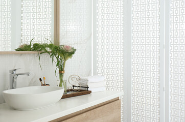 Poster - Bathroom counter with stylish vessel sink and bouquet. Interior design