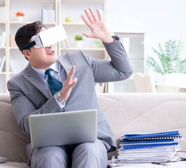 Businessman with virtual reality glasses in modern technology co