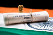 Indian constitution or Bharatiya Savidhana preamble old scattered text paper placed on Indian flag - Concept of Freedom, Nationality and patriotism.