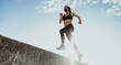 © Jacob Lund - Female athlete running in sunny morning