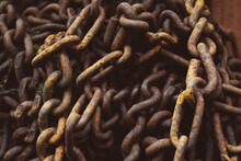 Closeup Of Old Weathered Rusty Giant Metallic Chains On Each Other In The Garden