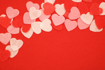 Wall Mural - Red pink and white hearts on a red background. Valentine's day concept. Selective focus. Postcard. Background.