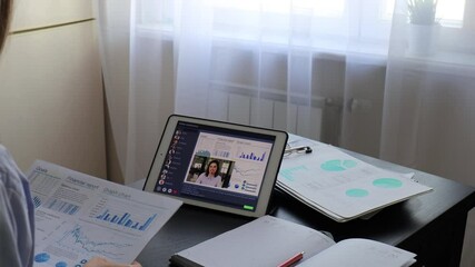 Poster - Woman having video conference with colleagues at table. Multiethnic business team working from home using digital tablet, discussing financial report of their company.