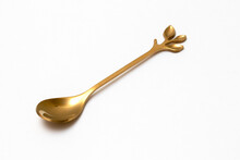 Top View Of Golden Spoon Isolated White Background.