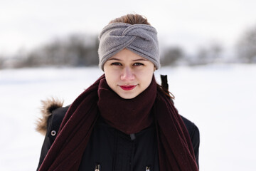 Young girl in winter clothes with snow