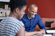 © Wavebreak Media - Diverse business people sitting going through paperwork in a modern office