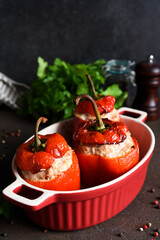 Wall Mural - Stuffed peppers baked with meat and rice on a dark concrete background