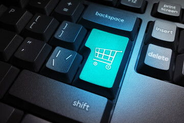 Poster - Shopping online. Shopping in online stores. Key with a shopping cart on the computer keyboard. Electronic business. Sale of goods via the Internet. E-shop concept.