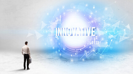 Poster - Rear view of a businessman standing in front of INNOVATIVE inscription, modern technology concept