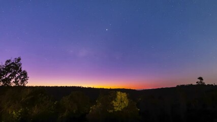 Wall Mural - awe time lapse view of the sky going from sunset to night at an amazing scenery inside a forest. a c