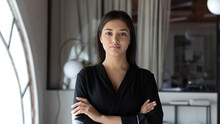 Head Shot Portrait Confident Indian Businesswoman Hr Manager Standing In Modern Office With Arms Crossed, Serious Entrepreneur Team Leader Mentor Posing For Corporate Photo, Looking At Camera