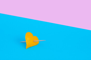 Creative minimal Valentines day concept with heart shape made of lemon peel and toothpick 