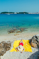 Wall Mural - woman sunbathing at sea beach in sunny day