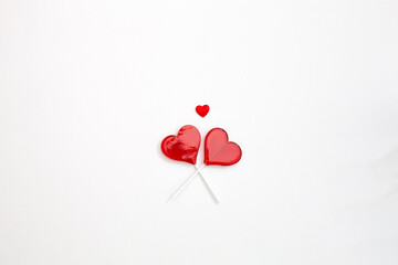 two red Valentine's day heart shape lollipop candy on empty white paper background. Love Concept. top view. Minimalism colorful hipster style. banner