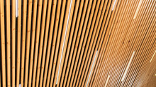 Close-up On A Ceiling Made Of Wooden Planks With LED Strip Lamps. The Texture Of Wooden Boards. Idea For A Wooden Plank Ceiling Design For A Loft-style Interior.