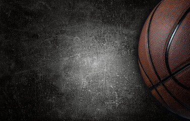 Basketball ball on dark concrete wall texture background. Background for product display, banner, or mockup