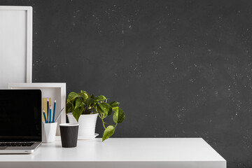 Wall Mural - Table with laptop, office supplies, plant and space for mockup. Home office desk.