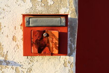 A Retro Looking Red Mailbox, Or Letterbox, Affixed To The Exterior Red And White Wall 